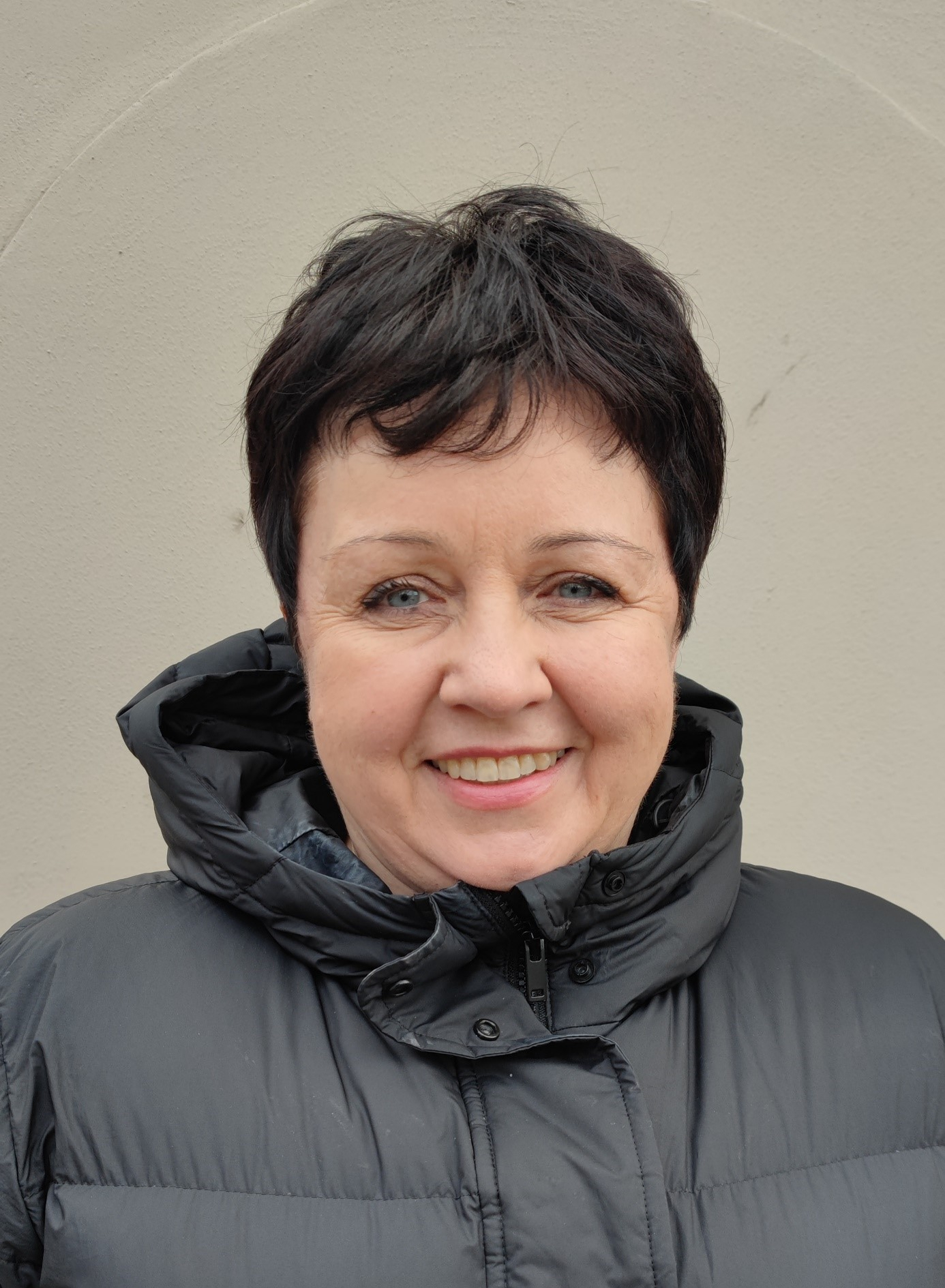 smiling woman with short, dark hair